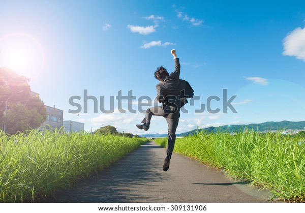business man jump with blue sky, full length, asian male
