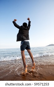 A Business Man Jumping On The Beach, Freedom, Success Concept