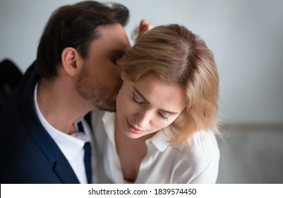 Business Man Kissing Neck Of Young Blonde Woman Closed Eyes. Passion Kiss. Enjoyment Or Workplace Romance Concept.