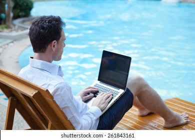 Business Man With Laptop In Luxury Hotel Near Swimming Pool