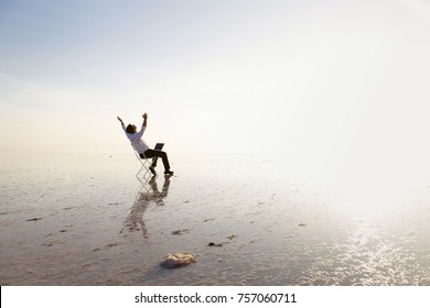 Business Man With Laptop Working On The Beach.Freelancer, Happy Successful Businessman On The Beach