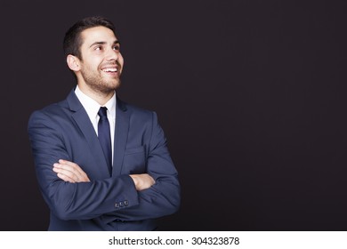 Business Man Looking Up Against Dark Background