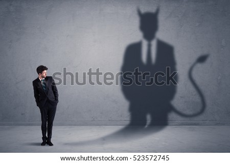 Business man looking at his own devil demon shadow concept background