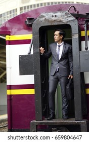 The Business Man With Luxury Suit  Standing On The Local Subway Train Door.
Young Man Standing At The End Of Train.  Business Trip On The Subway Train.