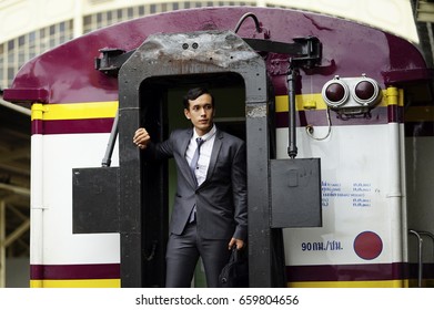 The Business Man With Luxury Suit  Standing On The Local Subway Train Door.
Young Man Standing At The End Of Train.  Business Trip On The Subway Train.