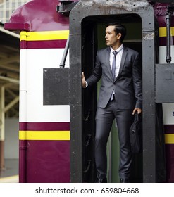 The Business Man With Luxury Suit  Standing On The Local Subway Train Door.
Young Man Standing At The End Of Train.  Business Trip On The Subway Train.