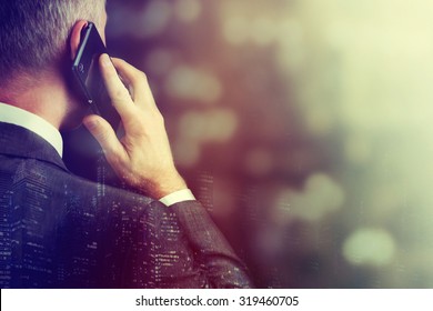 Business man making a phone call with smartphone.
