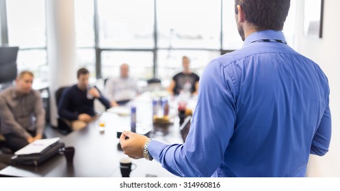 Business man making a presentation at office. Business executive delivering a presentation to his colleagues during meeting or in-house business training, explaining business plans to his employees.  - Shutterstock ID 314960816