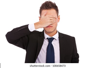 Business Man Making The See No Evil Gesture Over White . Young Businessman Covering His Eyes With His Hand