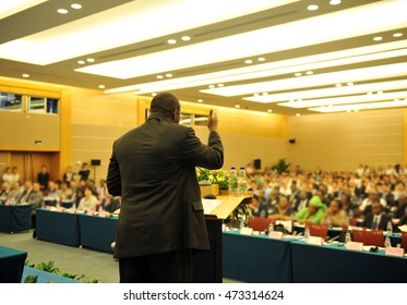 Business Man Is Making A Speech In Front Of A Big Audience At A Conference Hall.