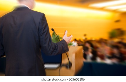 Business Man Is Making A Speech In Front Of A Big Audience At A Conference Hall.
