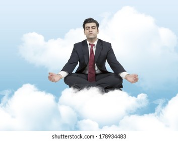 Business Man Meditates On Clouds 