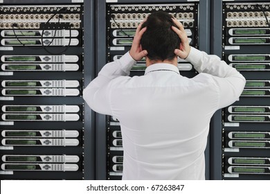 Business Man In Network Server Room Have Problems And Looking For  Disaster Solution