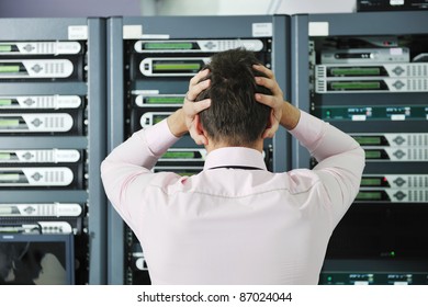 It Business Man In Network Server Room Have Problems And Looking For  Disaster Situation  Solution