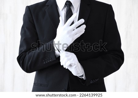 Business man with no face wearing white glove