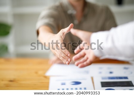 Business man offer and give hand for handshake in office. Successful job interview. Apply for loan in bank. Salesman, bank worker or lawyer shake for deal, agreement or sale. Increase of salary.