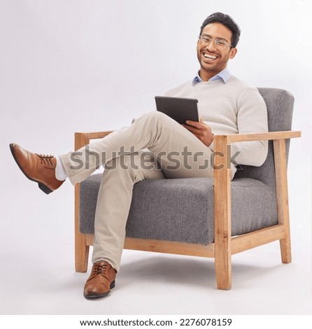 Business man on armchair isolated on a white background happy therapist portrait, career mindset and work on tablet. Asian professional person or psychologist relax on chair, digital tech and studio