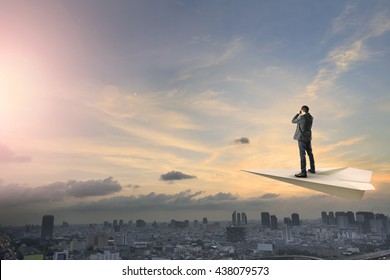 Business Man On Paper Plane Using Binocular Lens