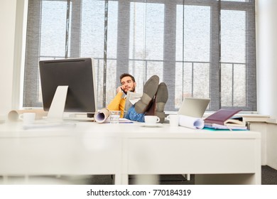 Business man on the phone relaxed at place of work - Shutterstock ID 770184319