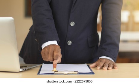 Business Man Person's Hand Stamping With Approved Stamp On Certificate Document Public Paper At Desk, Signing On Business Partner Paper To Success, Or Concept Of Attorney And Insurance