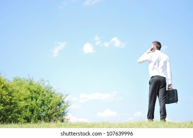 Business Man With Phone In Nature