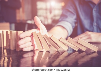 Business man placing wooden block on a tower concept risk control, Planning and strategy in business.Alternative risk concept,Risk To Make Buiness Growth Concept With Wooden Blocks