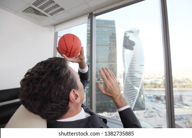 Business Man Playing With A Basketball At The Office