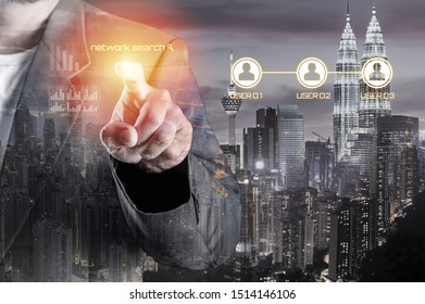 Business Man With Pointing To Something Or Touching A Touch Screen Overlay With Cityscape. Double Exposure. Business And Technology Concept