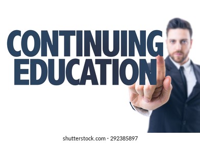 Business Man Pointing The Text: Continuing Education