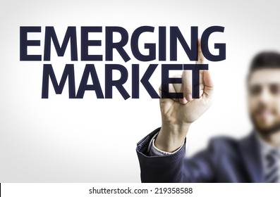 Business man pointing to transparent board with text: Emerging Market - Shutterstock ID 219358588