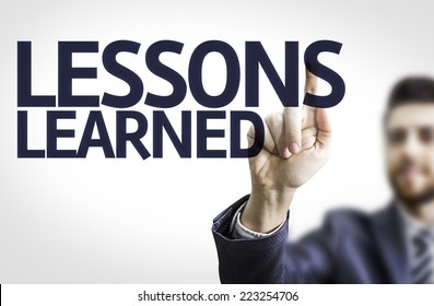 Business Man Pointing To Transparent Board With Text: Lessons Learned