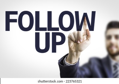 Business Man Pointing To Transparent Board With Text: Follow Up