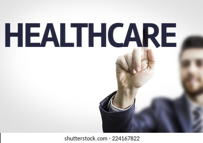 Business Man Pointing To Transparent Board With Text: Healthcare