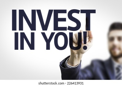 Business Man Pointing To Transparent Board With Text: Invest In You