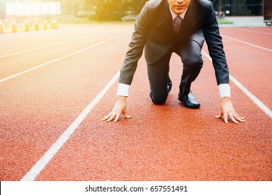 Business man preparing to run on the competition running track - Shutterstock ID 657551491
