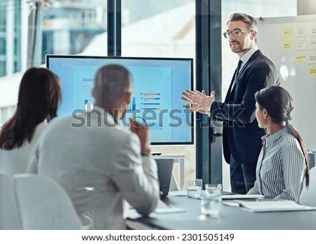 Business man, presentation and graph screen in office for training, meeting or workshop. Men and women at table to listen to speaker, coach or manager talking about strategy, sales growth or pitch