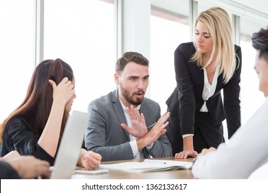 Business Man Presenting And Disagree Sign  In Meeting Room . Group Of Young Business People Brainstorming Together In Office. Teamwork Conference. Discussing Reject New Plan 