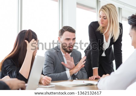 business man presenting and disagree sign  in meeting room . Group of young business people brainstorming together in office. teamwork conference. discussing reject new plan 