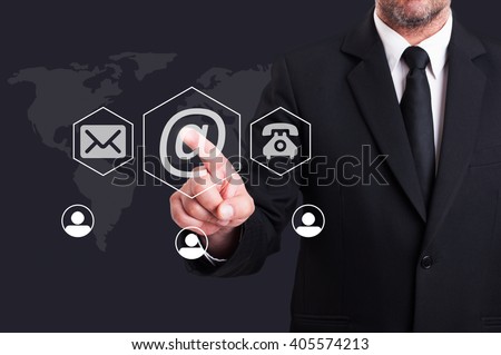 Business man pressing contact us using email digital button on futuristic transparent screen
