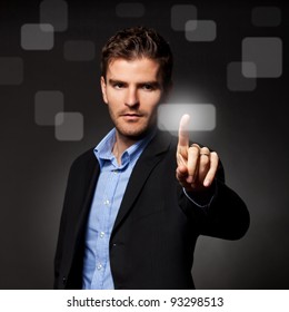 Business Man Pressing A Touchscreen Button On Dark Background