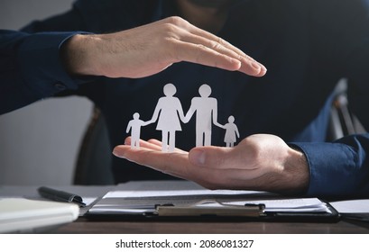 Business man protect paper cut family. Family insurance - Powered by Shutterstock