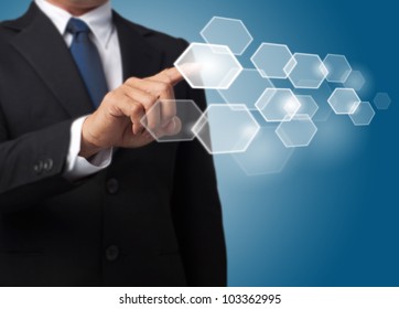 business man push a hexagonal touch screen button