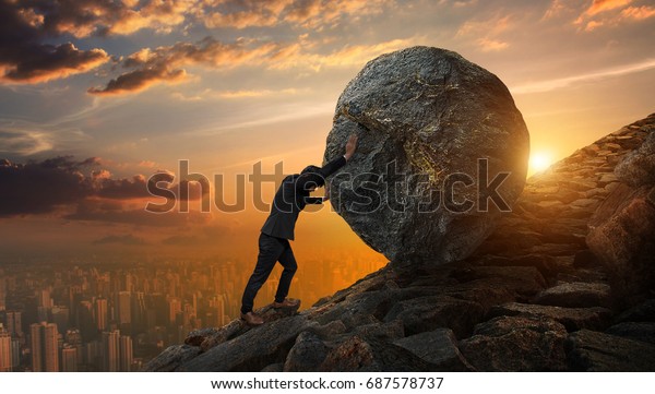 Business man pushing large stone up to\
hill , Business heavy tasks and problems\
concept.