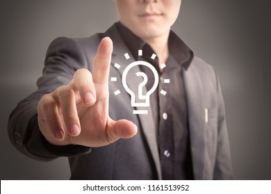 Business Man Pushing On A Light Bulb Icon Technology And Inovation Concept
