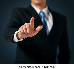 Business Man pushing on a touch screen interface - Powered by Shutterstock