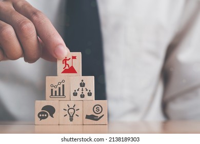 Business man puts the wooden cube with success icon standing with the success factors; experience, personal, network, relationship, vision. Leader and C-suite reaching concept. - Shutterstock ID 2138189303