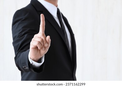 Business man putting up index finger - Powered by Shutterstock