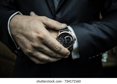 A Business Man Putting On Luxury Watch And Checking Time 