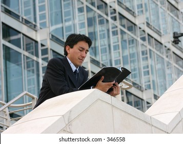 Business Man Reading A Magazine In A Corporate Environment