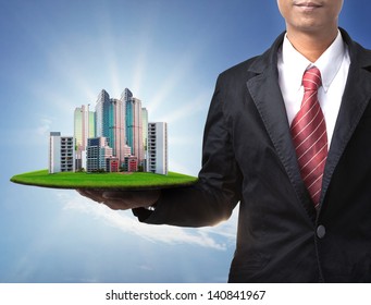 Business Man And Real Estate In Hand Use For Property Land Management And  Building Construction Theme